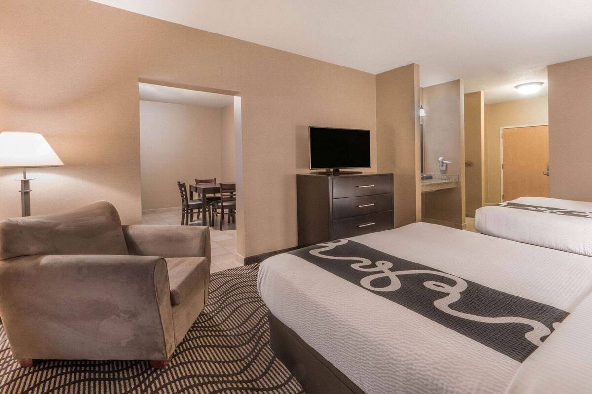 Premium bedding, desk, laptop workspace, blackout drapes