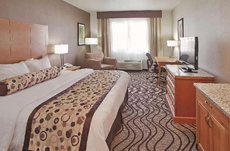 Premium bedding, desk, laptop workspace, blackout drapes