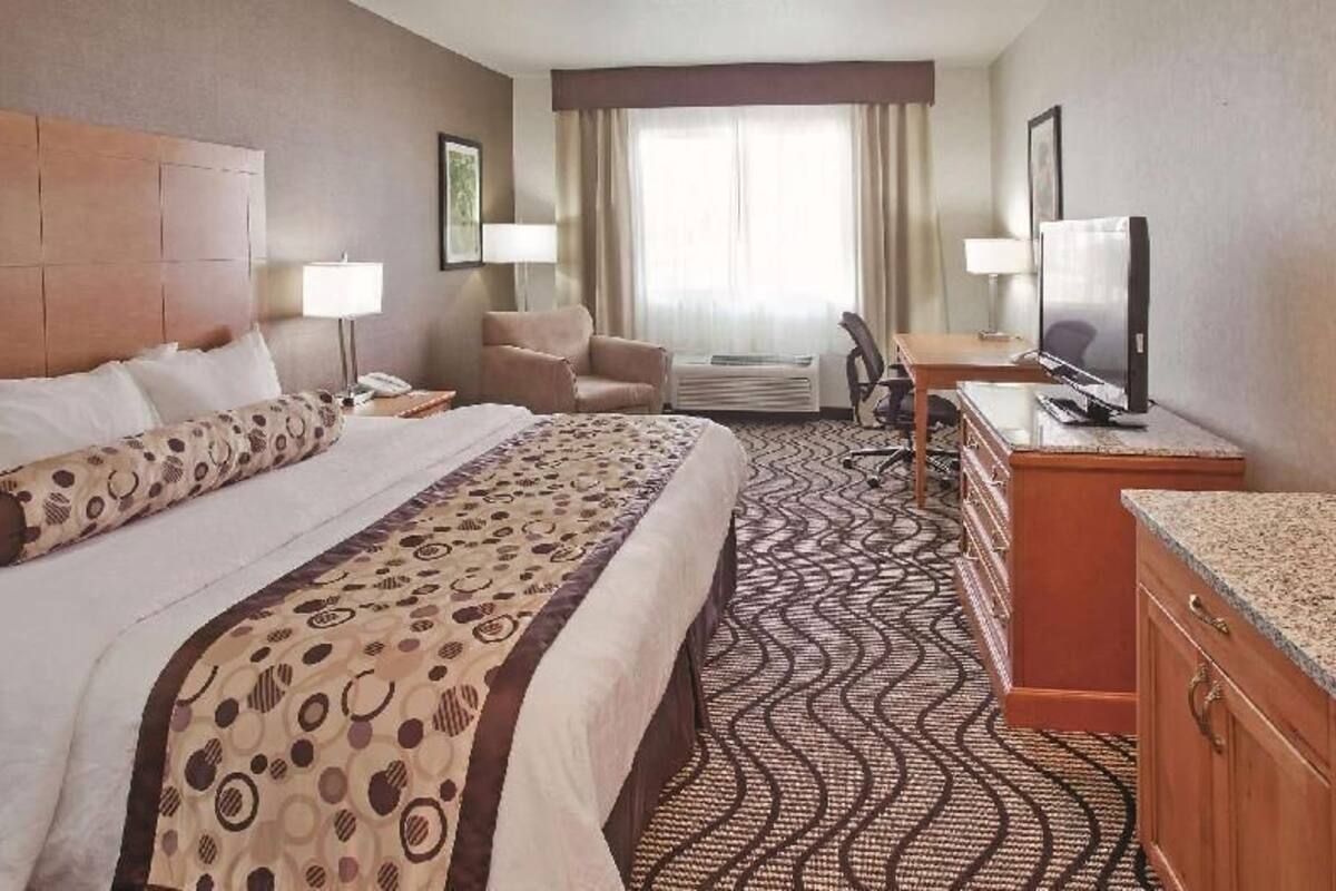 Premium bedding, desk, laptop workspace, blackout drapes