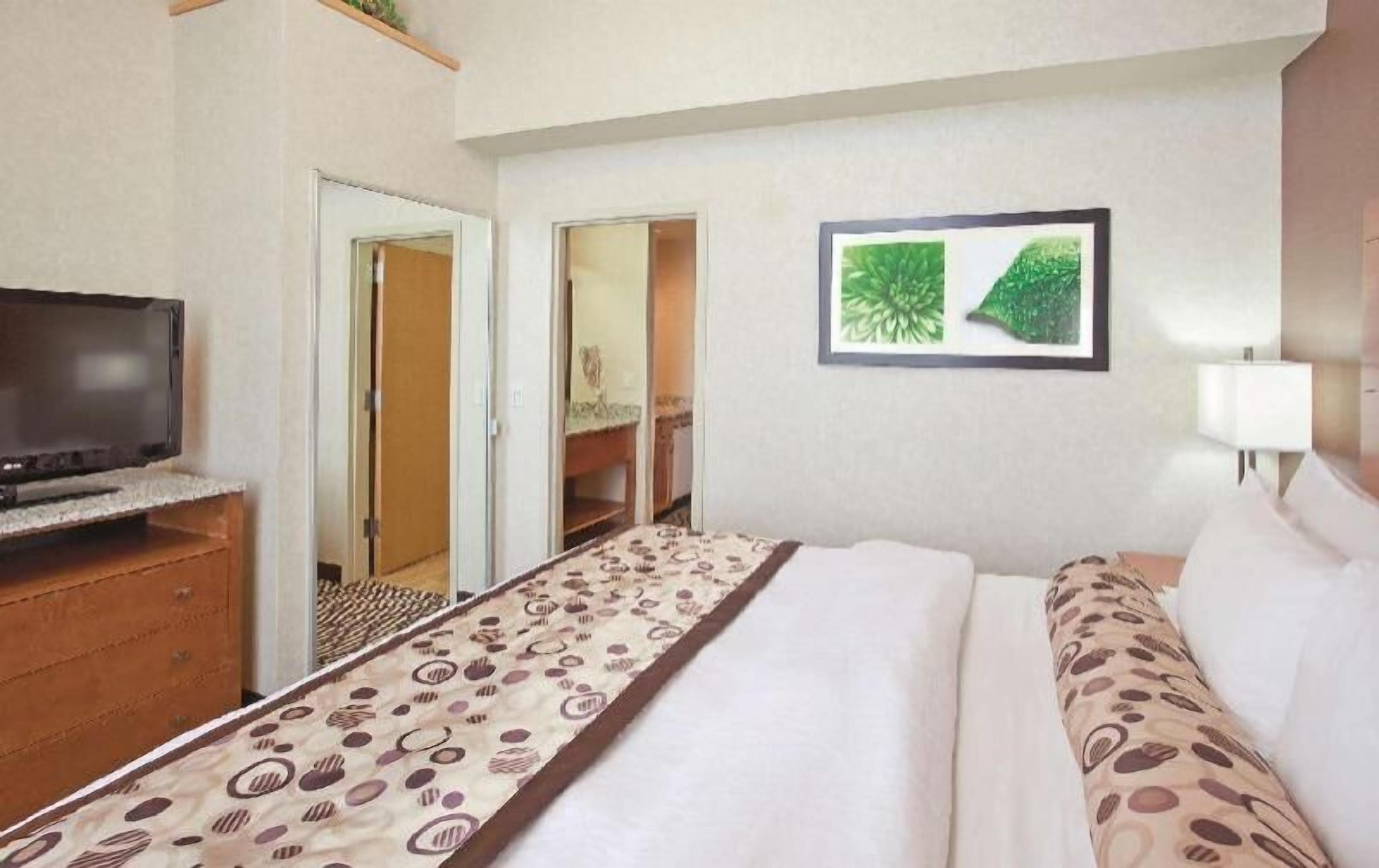 Premium bedding, desk, laptop workspace, blackout drapes
