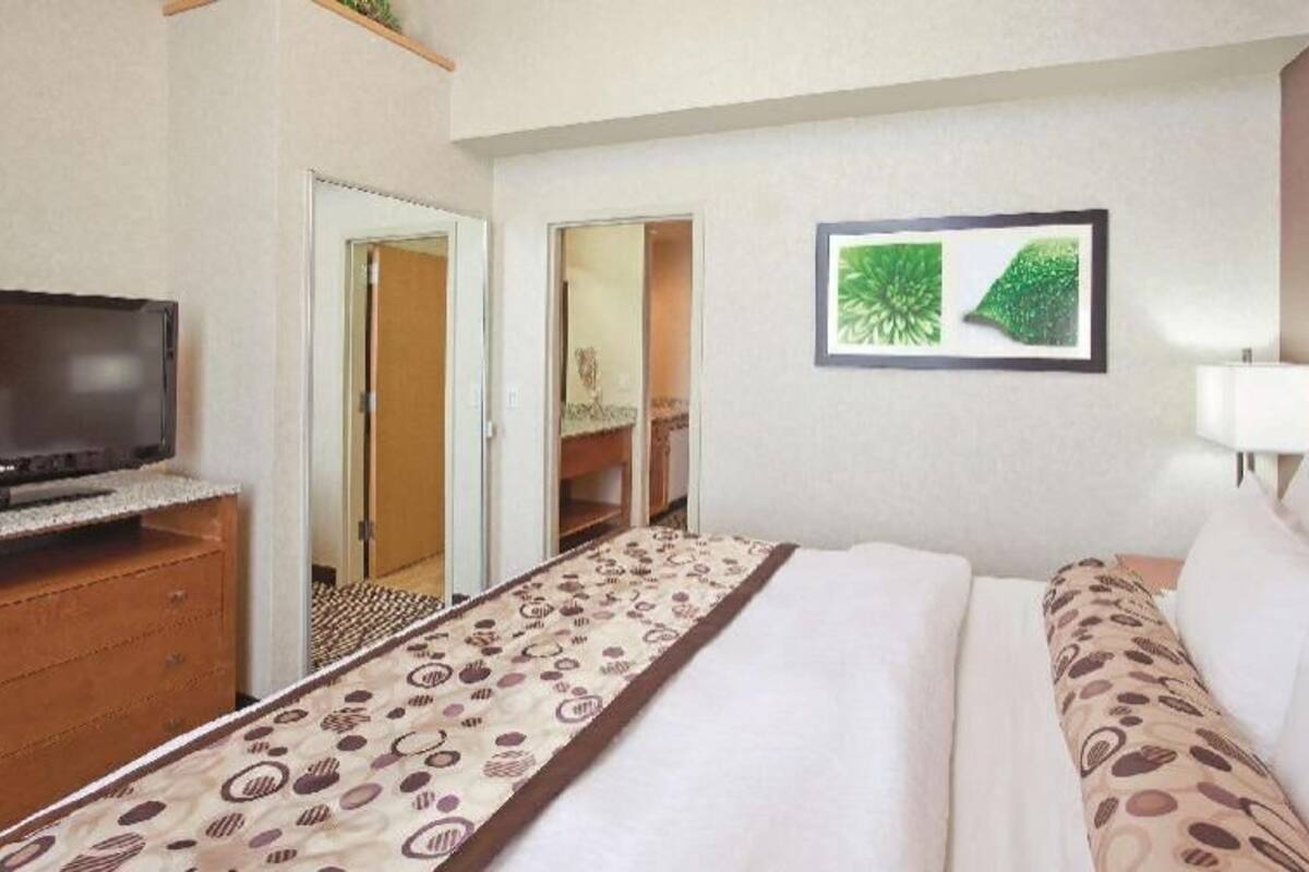 Premium bedding, desk, laptop workspace, blackout drapes