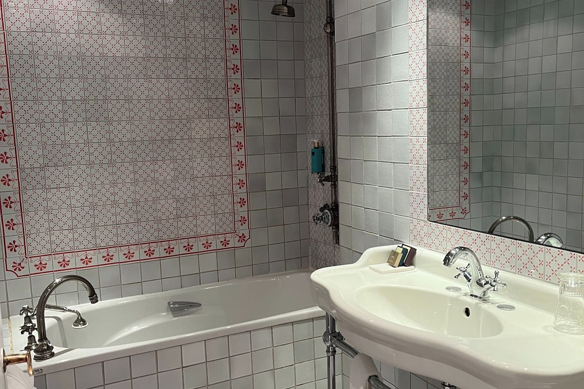 bathtub, designer toiletries, hair dryer, bathrobes