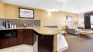 Suite, 1 King Bed, Non Smoking, Jetted Tub (Separate Living Room) | Desk, laptop workspace, blackout drapes, iron/ironing board