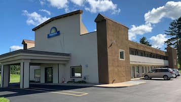 Welcome to Days Inn, featuring a modern architectural design with a covered parking area and convenient entrance.