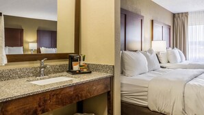 A hotel room with a granite countertop sink, a coffee maker, and a bed with white linens. - Comfort Inn Norwalk - Sandusky (Norwalk)