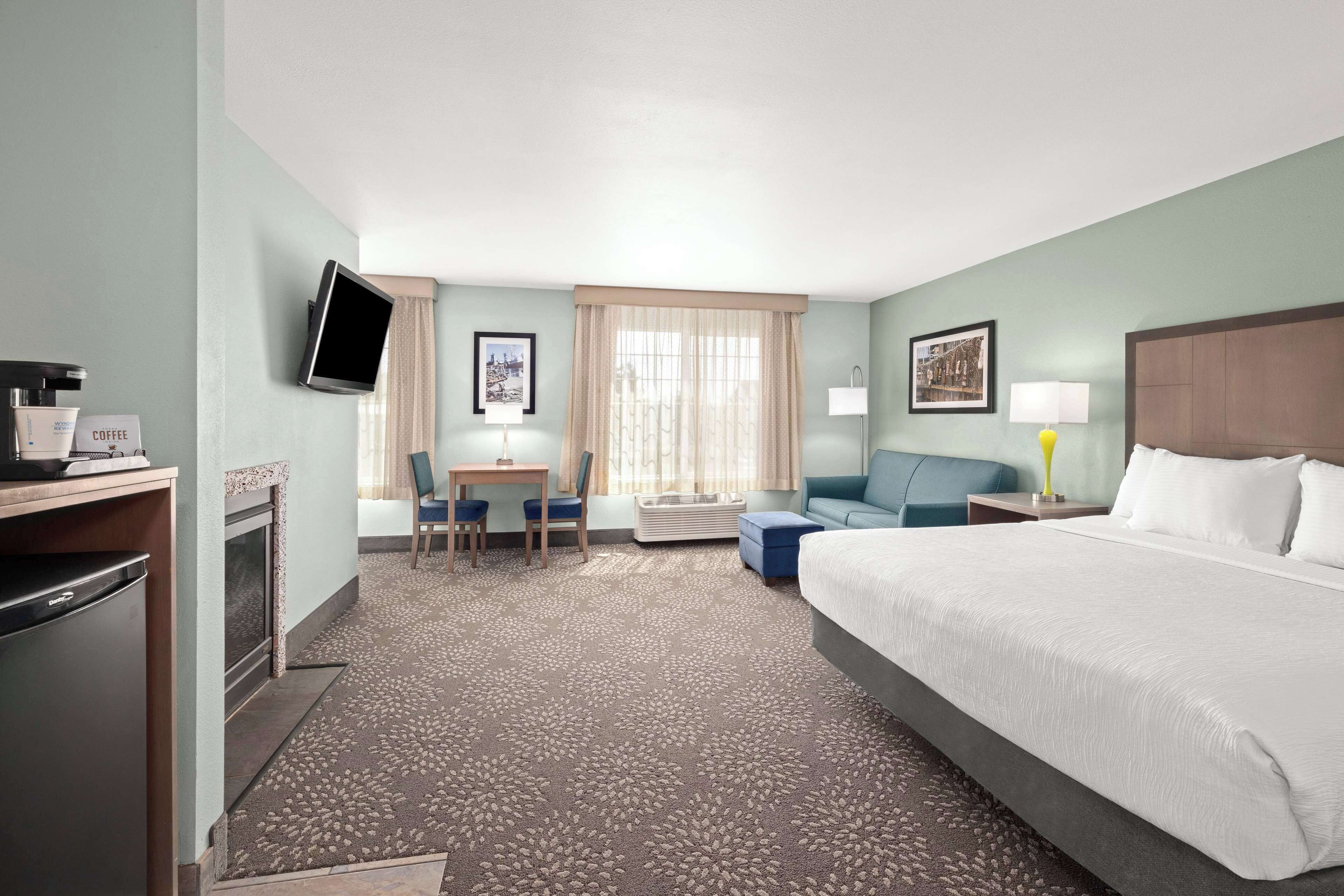 deluxe suite, 1 king bed, non smoking | premium bedding, laptop workspace, blackout curtains, iron/ironing board