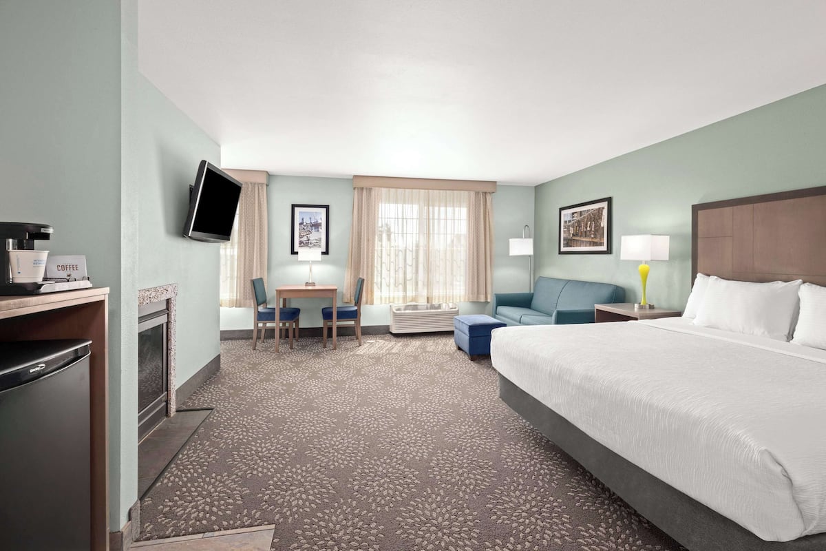 deluxe suite, 1 king bed, non smoking | premium bedding, laptop workspace, blackout curtains, iron/ironing board