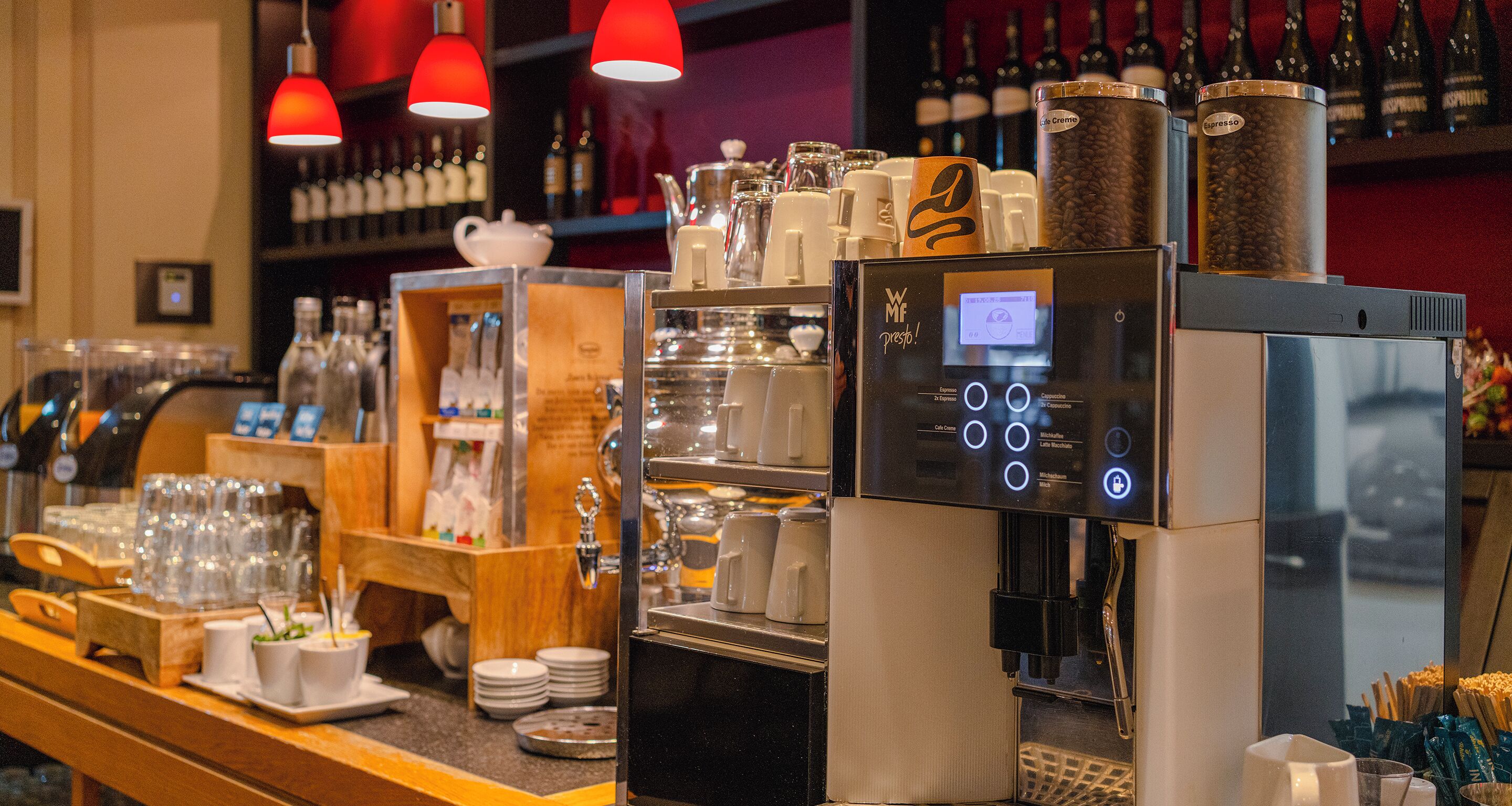 A coffee machine with a digital display, a coffee grinder, and a coffee press.