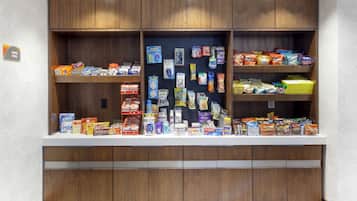 A snack bar with various food items and beverages.