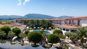 A resort with multiple buildings, a swimming pool, and palm trees. - Zante Park Resort & Spa, BW Premier Collection (Zakynthos)