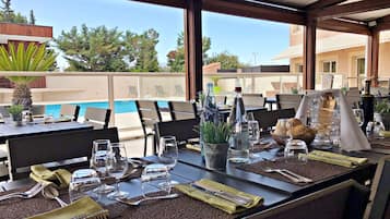 Breakfast, lunch, dinner served; international cuisine, pool views
