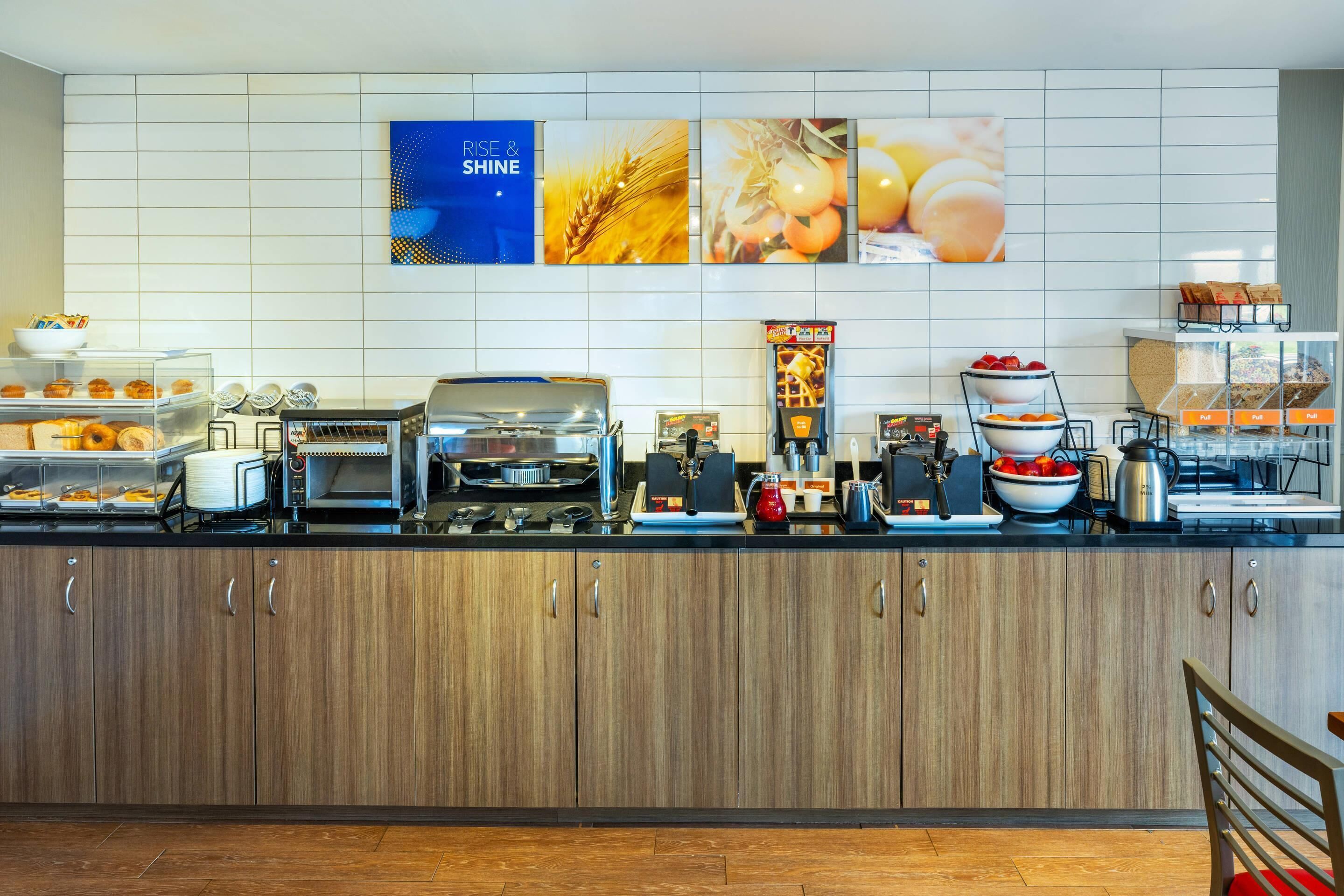 A modern kitchen with a coffee machine, toaster, and various food items on the counter.
