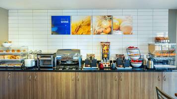 A modern kitchen with a coffee machine, toaster, and various food items on the counter.