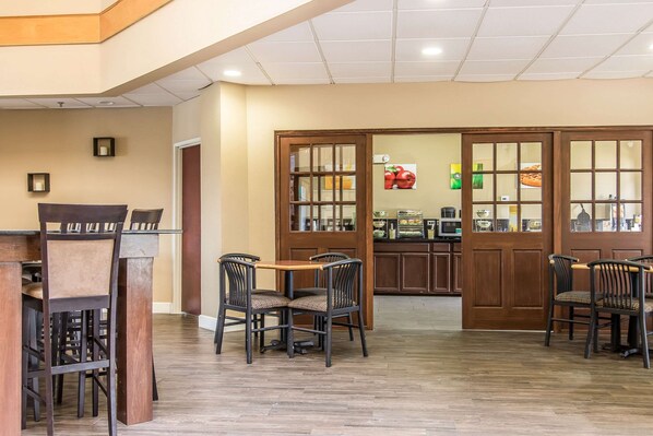 A restaurant with wooden furniture and a tiled floor.