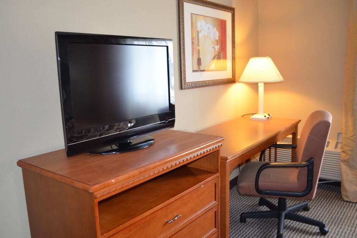 Desk, laptop workspace, blackout drapes, iron/ironing board