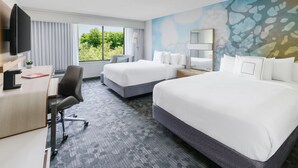 A hotel room with two beds, a desk with a chair, a TV, and a large window with curtains. - Courtyard By Marriott Dallas - Lewisville (Lewisville)