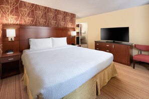 Relax in comfort with a large bed, flat-screen TV, and convenient workspace.