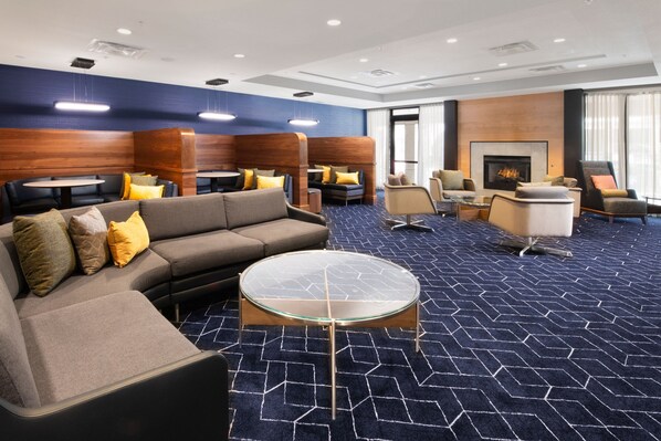Relax in a comfortable seating area with sofas and armchairs, a central coffee table, and a fireplace.