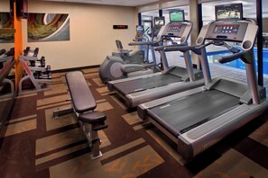 A hotel gym with treadmills, an elliptical, and a bench. - Courtyard by Marriott Philadelphia Plymouth Meeting (Plymouth Meeting)