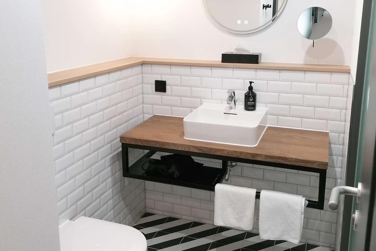 penta family apartment | bathroom | shower, rainfall showerhead, eco-friendly toiletries, hair dryer