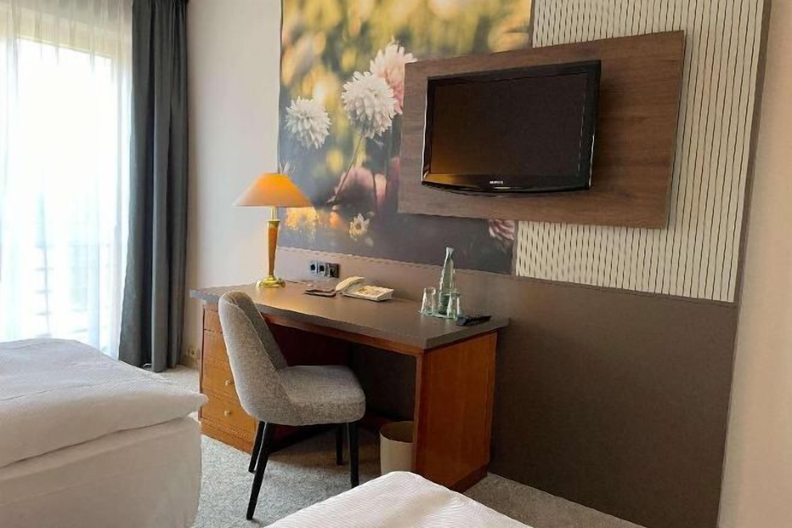 Hypo-allergenic bedding, desk, laptop workspace, blackout curtains