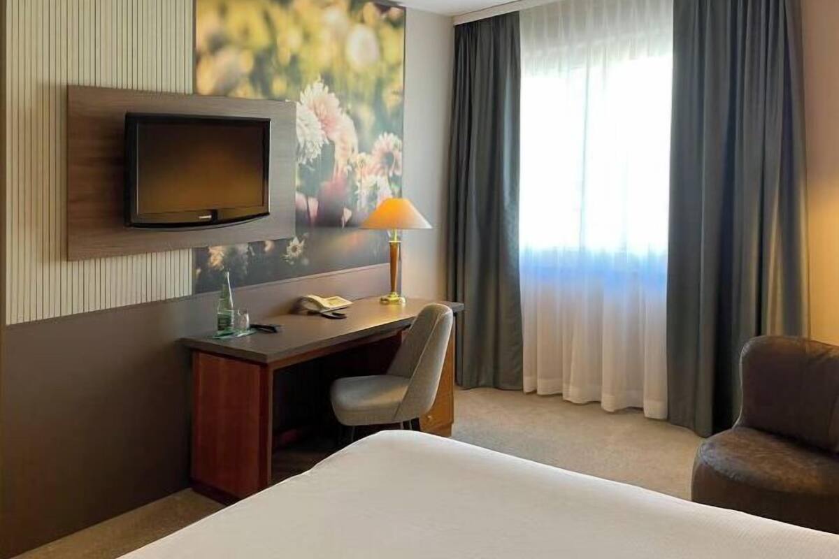 Hypo-allergenic bedding, desk, laptop workspace, blackout curtains