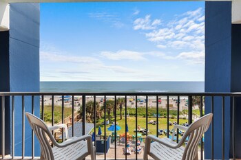 A hotel with multiple floors, a pool area, and a beach view. at Grande Shores Ocean Resort