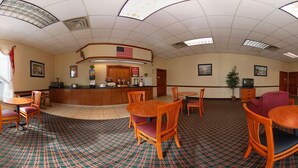 A hotel lobby with a reception desk, multiple seating areas, and a patterned carpet. - Econo Lodge Cullman South (Cullman)
