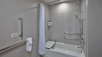 A modern bathroom with a walk-in shower, a bathtub, a towel rack, and a shower curtain.