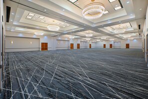 A large conference room with a high ceiling, multiple chandeliers, and a patterned carpet. - Embassy Suites by Hilton Franklin Cool Springs (Franklin)