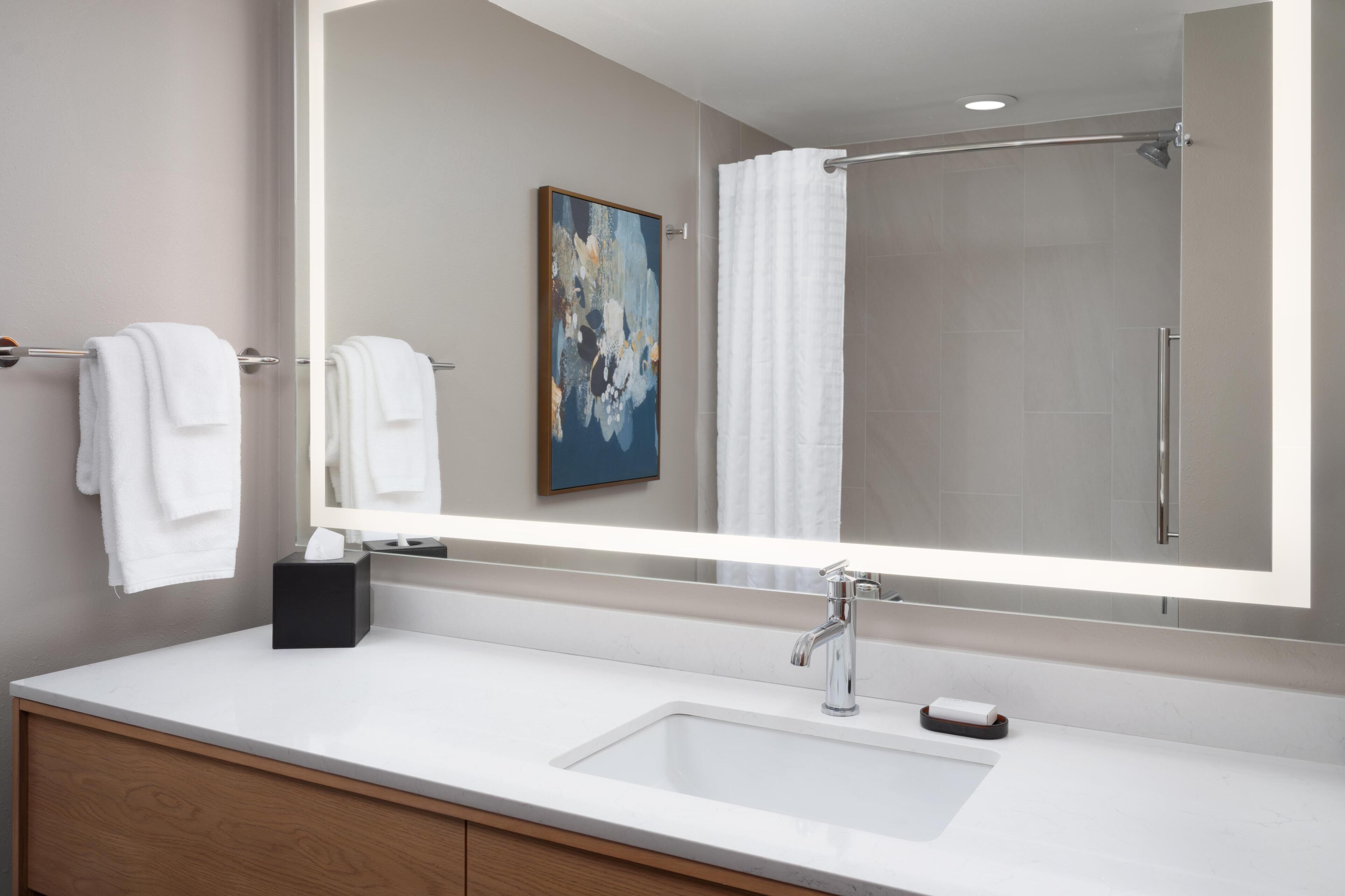 Designer toiletries, hair dryer, towels