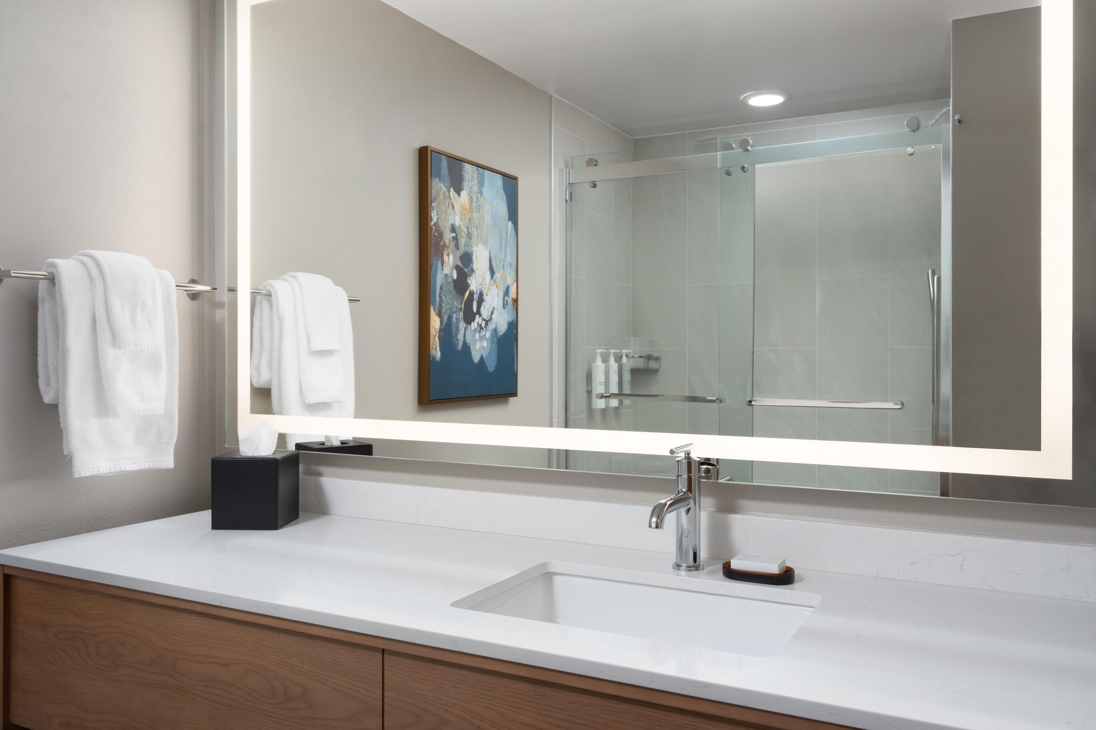 Designer toiletries, hair dryer, towels