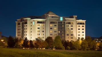 A multi-story hotel with a prominent 'E' sign, indicating an emergency exit.