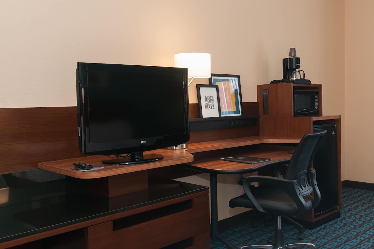 Desk, laptop workspace, iron/ironing board, free cribs/infant beds