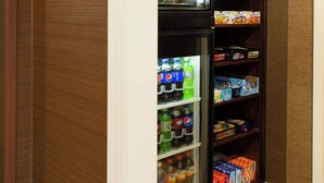 A corner market with a refrigerator stocked with beverages and snacks. - Fairfield Inn by Marriott Orangeburg (Orangeburg)