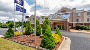 A Comfort Inn hotel with a brick facade, multiple windows, and a parking lot with neatly trimmed trees. - Comfort Inn & Suites Hillsville I-77 (Hillsville)