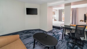 A hotel room with a bed, a desk, a chair, a television, and a small table. - Fairfield Inn & Suites Memphis I-240 & Perkins (Memphis)