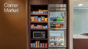 A Corner Market with shelves stocked with snacks, a microwave, and a refrigerator. - Fairfield Inn by Marriott Philadelphia Airport (Philadelphia)