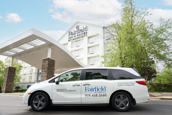 A white minivan with "Fairfield by Marriott" branding parked in front of a hotel. - Fairfield Inn by Marriott Raleigh Airport/RTP (Morrisville)