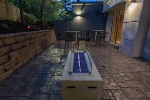 An outdoor patio with a rectangular water feature, stone steps, and seating areas. - Fairfield Inn by Marriott Raleigh Airport/RTP (Morrisville)