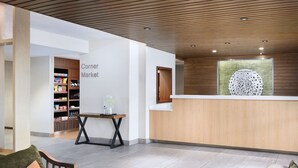 A modern lobby with a reception desk, a corner market, and seating areas. - Fairfield Inn by Marriott Raleigh Airport/RTP (Morrisville)