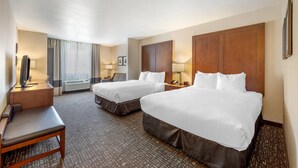 A hotel room with two beds, a desk, a chair, a TV, and a window with curtains. - Comfort Inn & Suites Orem - Provo (Orem)