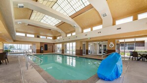 An indoor swimming pool with clear glass ceilings, a covered seating area, and a view of the outside. - Comfort Inn & Suites Orem - Provo (Orem)