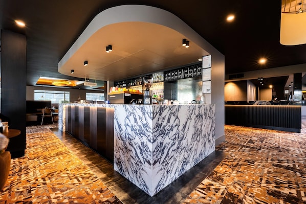 A marble bar with a cash register, shelves with liquor bottles, and a patterned carpet. - Quality Hotel Parklake Shepparton (Shepparton)