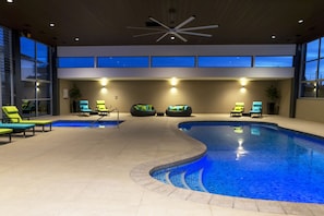 An indoor swimming pool with multiple lounge chairs and a ceiling fan. - Quality Hotel Parklake Shepparton (Shepparton)