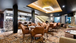 A modern hotel lobby with a bar area, seating arrangements, and a staircase leading to upper floors. - Quality Hotel Parklake Shepparton (Shepparton)