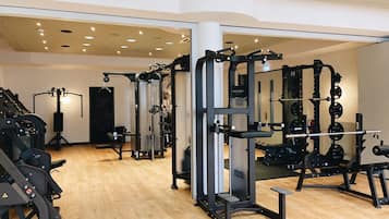 A gym with various exercise equipment, including weight machines and free weights.