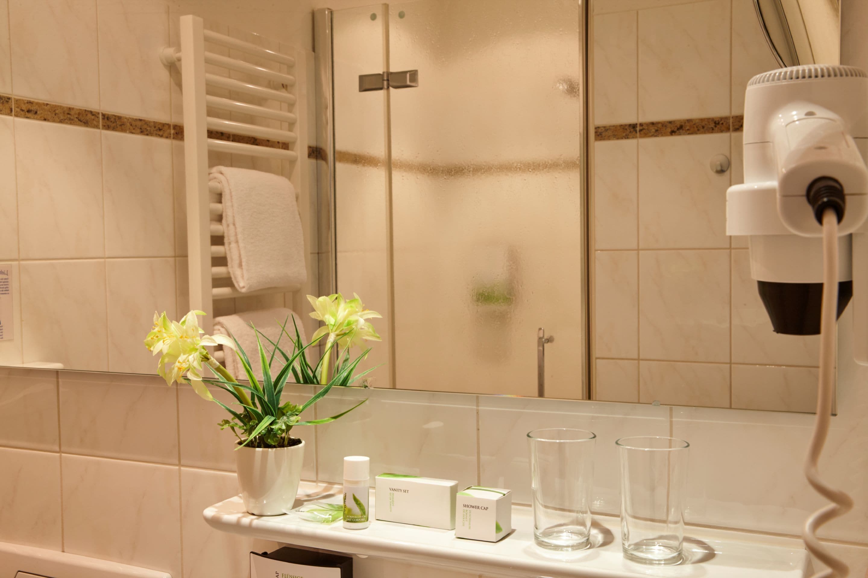 eco-friendly toiletries, hair dryer, slippers, towels