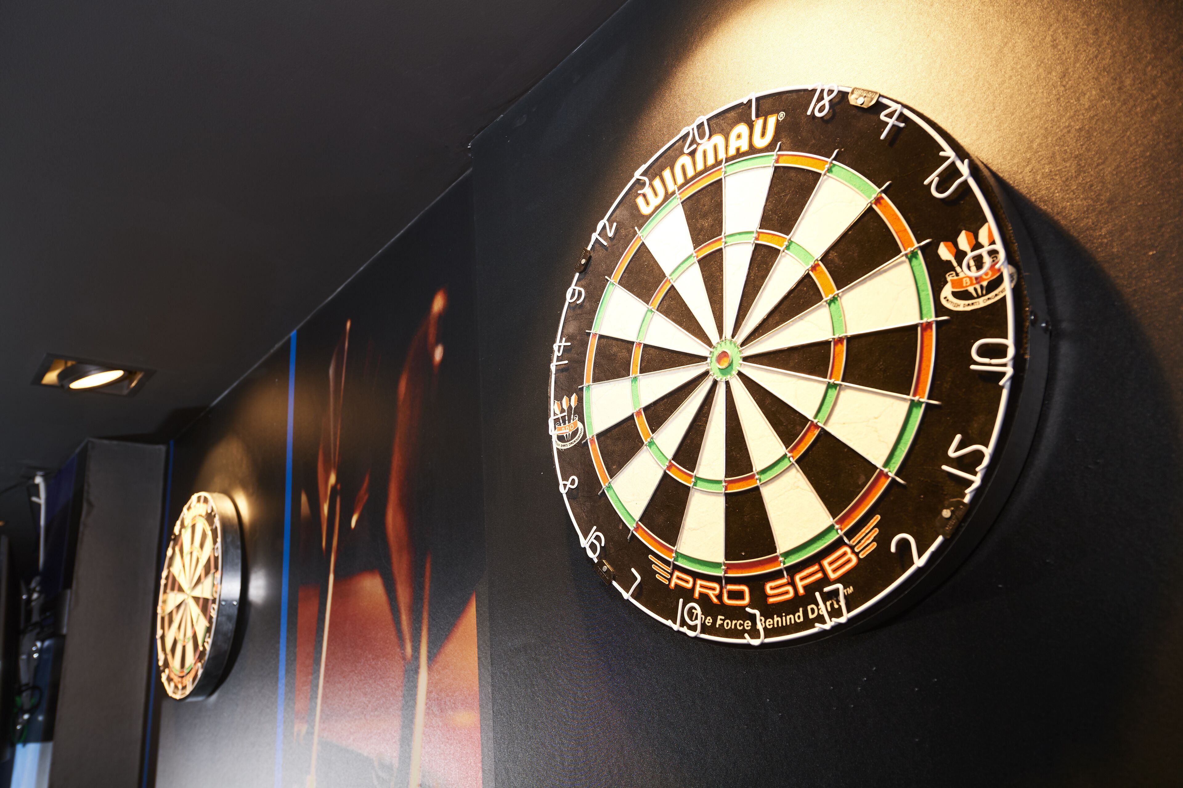 Two dartboards mounted on a wall.
