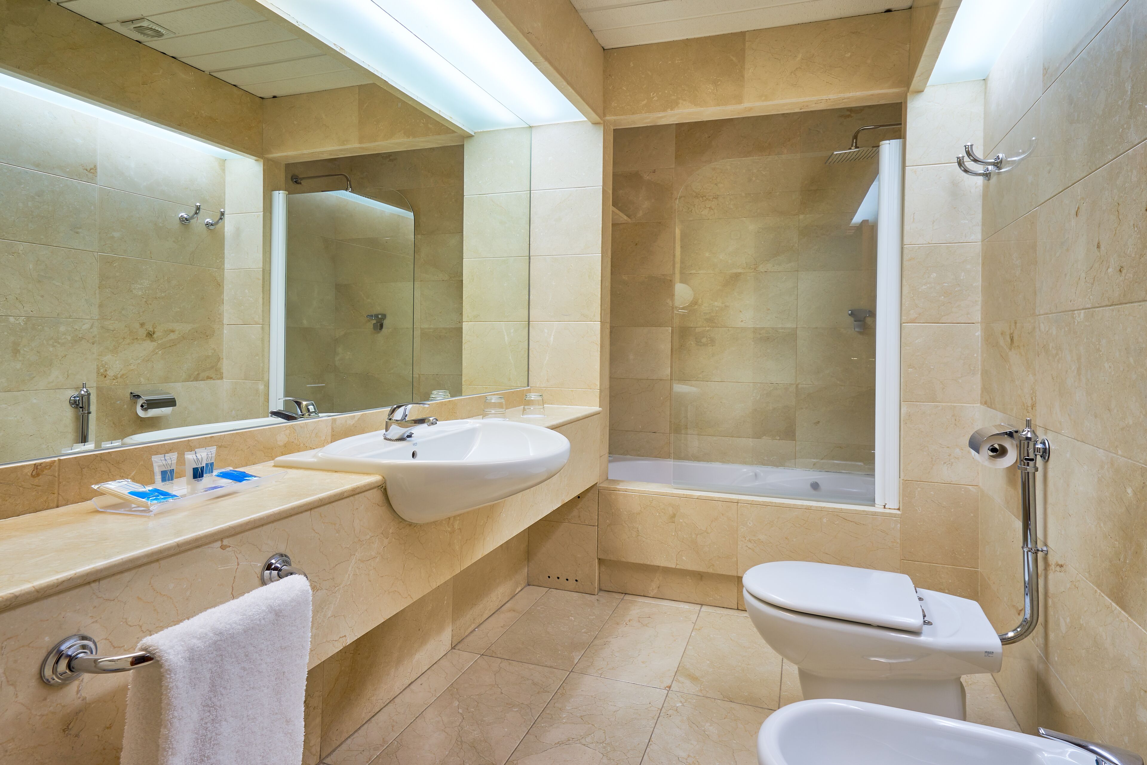 double or twin room | bathroom | combined shower/bathtub, deep-soaking bathtub, eco-friendly toiletries